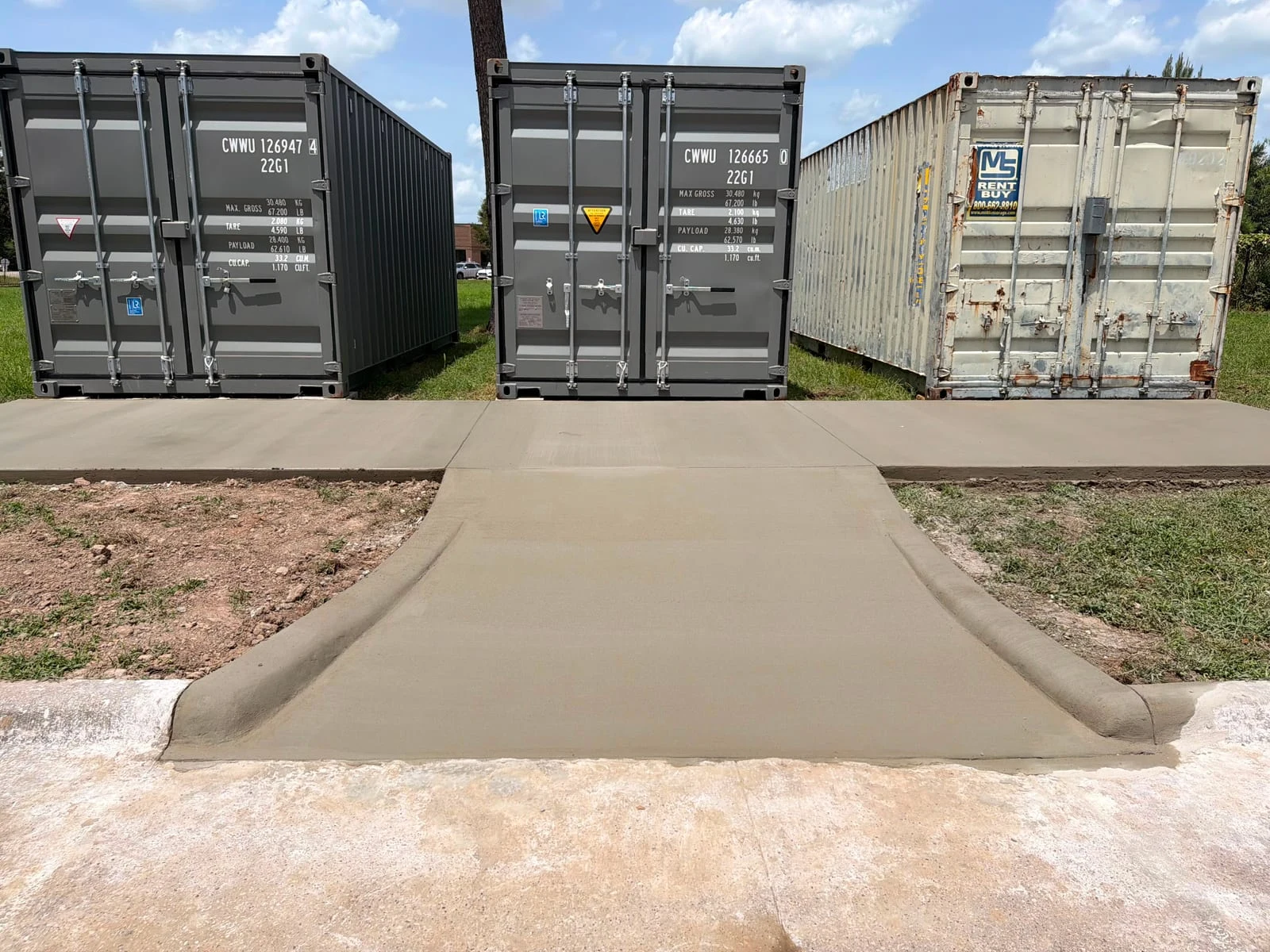 A finished concrete driveway curving away from the road
