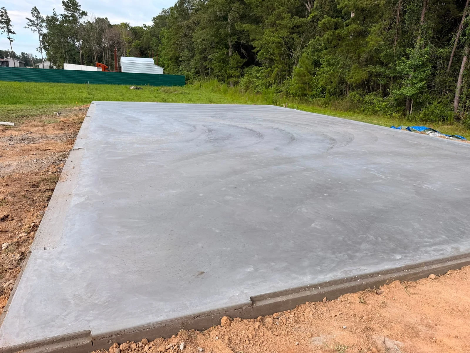 A poured concrete building slab with its edges formed and finished