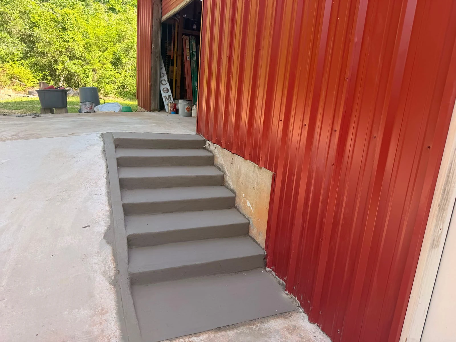 Poured concrete steps leading up to a landing