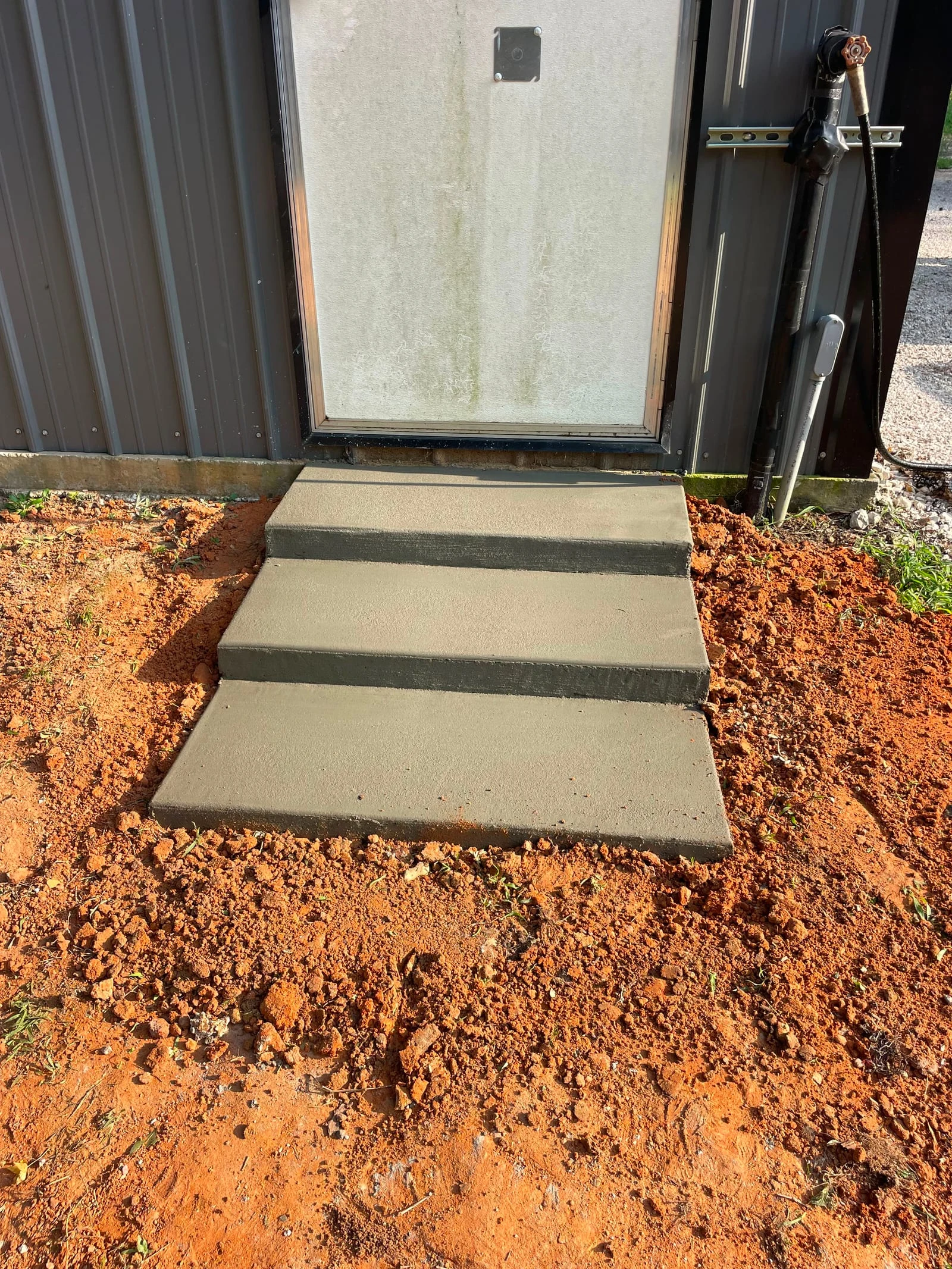 Poured concrete steps and landing by Santoyo’s Concrete