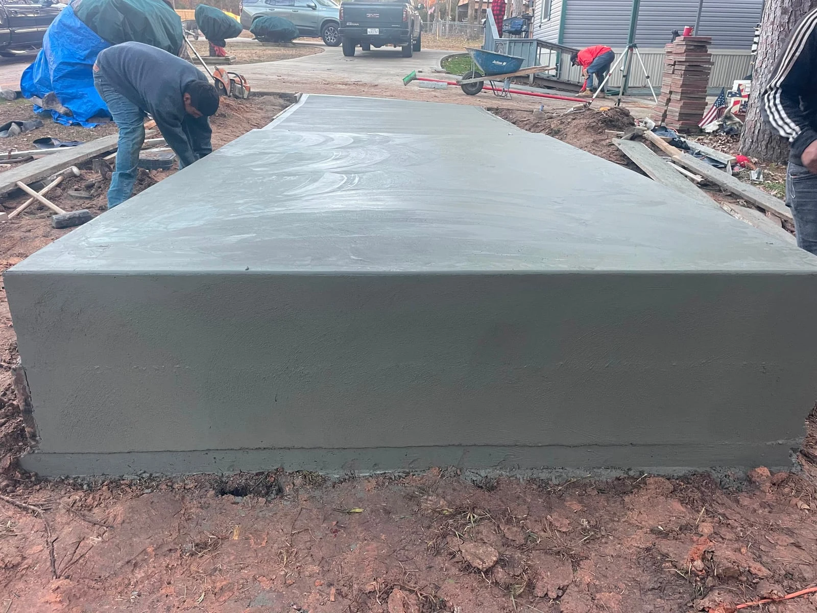 A cast-in-place concrete retaining wall holding back a slope